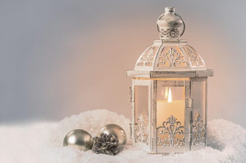 decorated lantern glowing on a snowy surface, New Year 2024