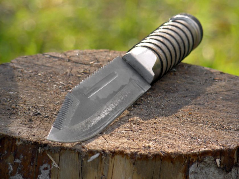 Tactical knife with a serrated blade